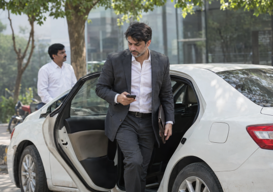 Executive Steps Out, Checking Phone (1)